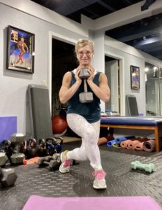 Balance is key when considering the best exercises for women over 40. This photo displays a lunge with weighted resistance.